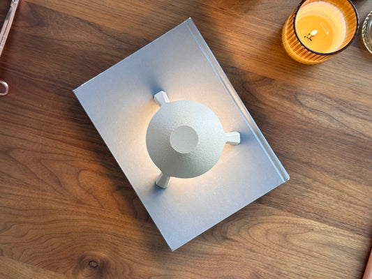 Soma lamp glowing softly at low brightness, cozy mood light for bedroom or living space