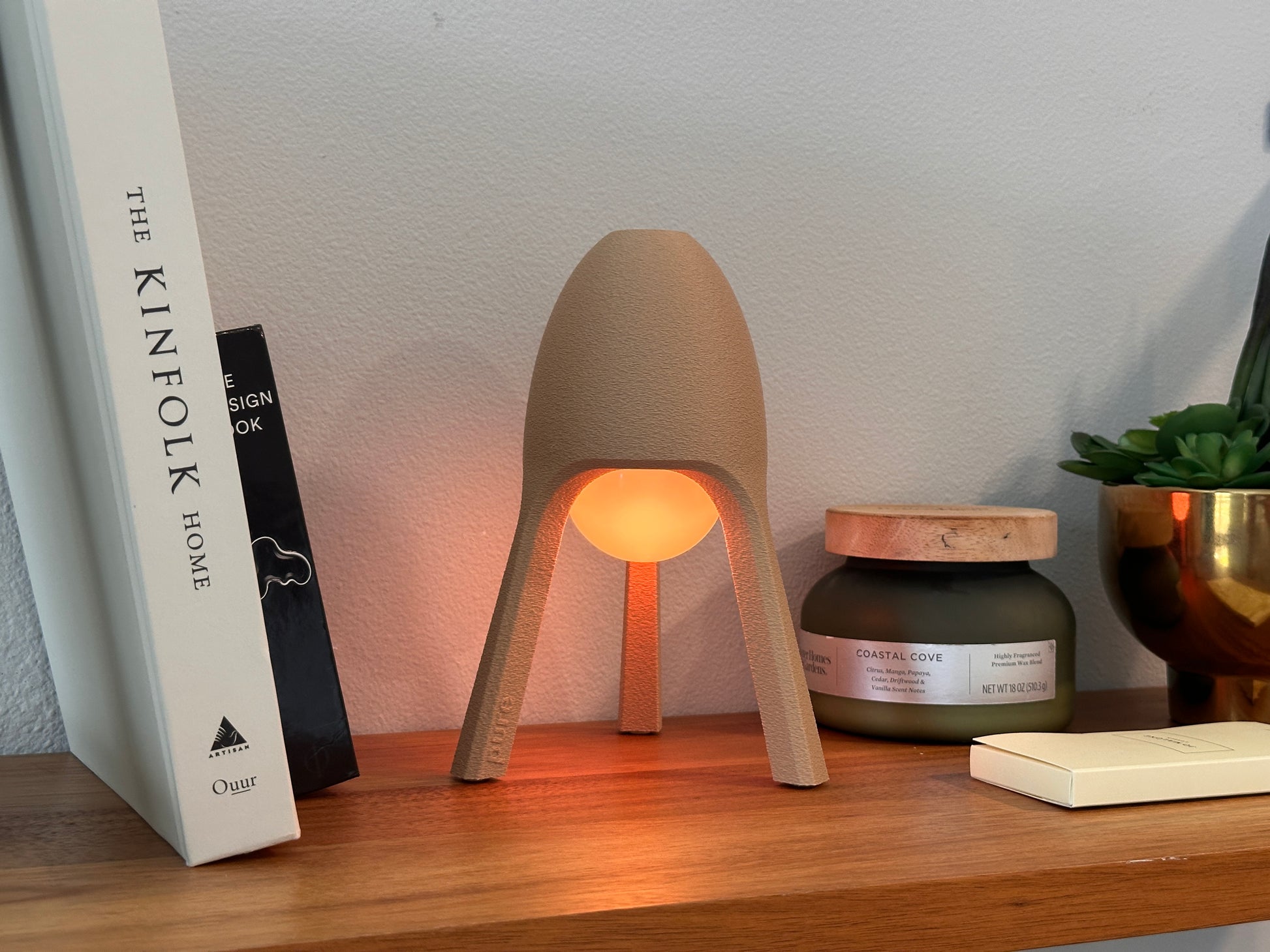 Soma wireless lamp on bookshelf, warm mood lighting, minimalist decorative accent for home