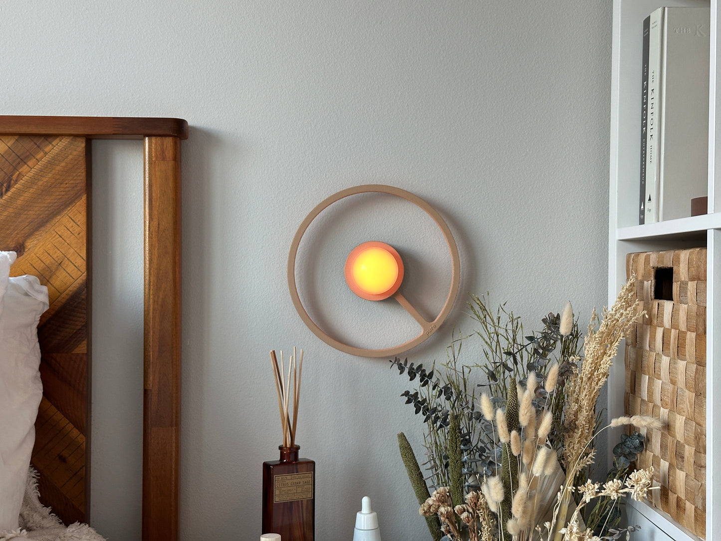 Ora wireless sconce and warm light in a room setting.