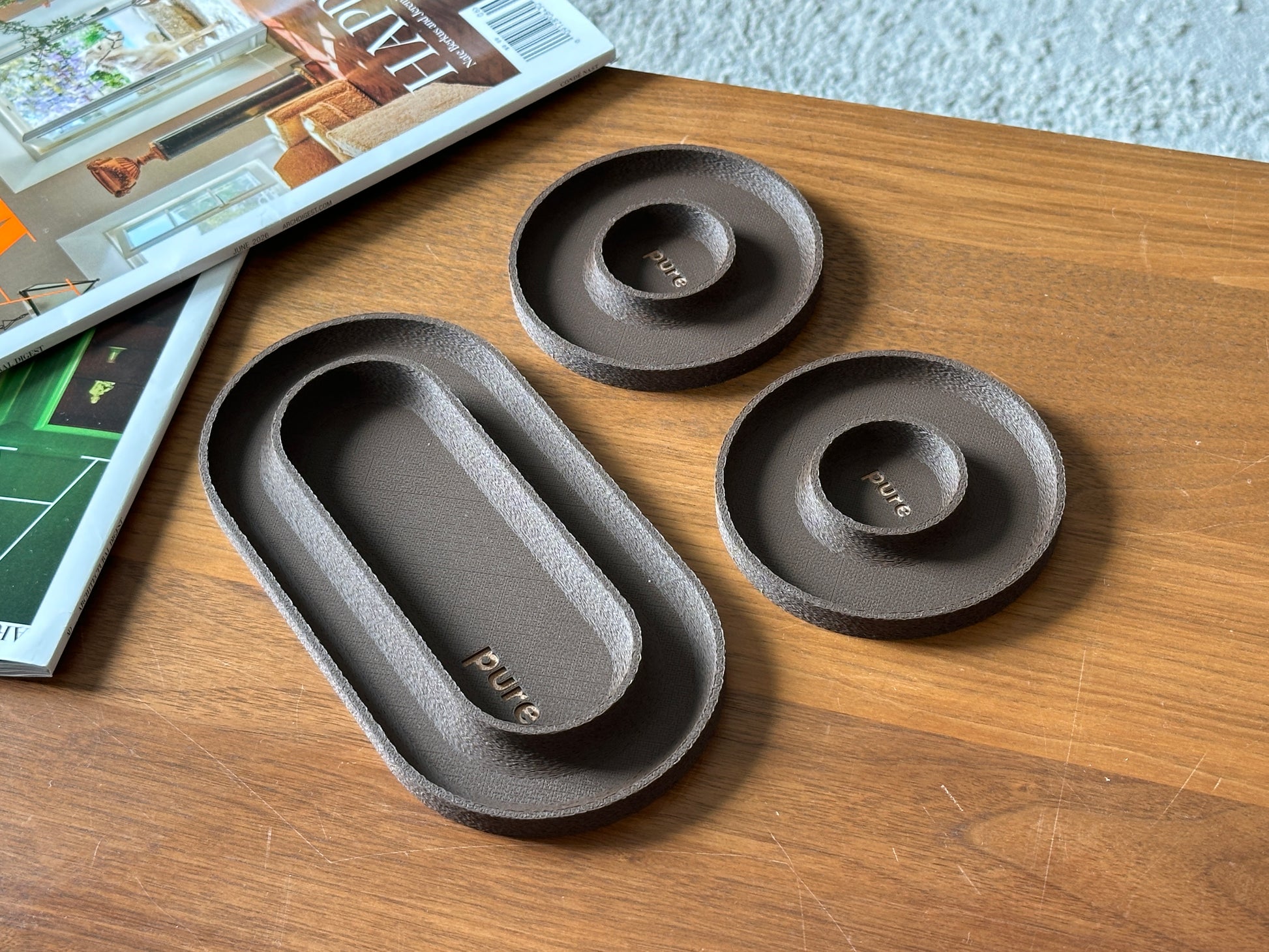 Chocolate brown 3-piece valet tray set with matte textured finish on a wood table.