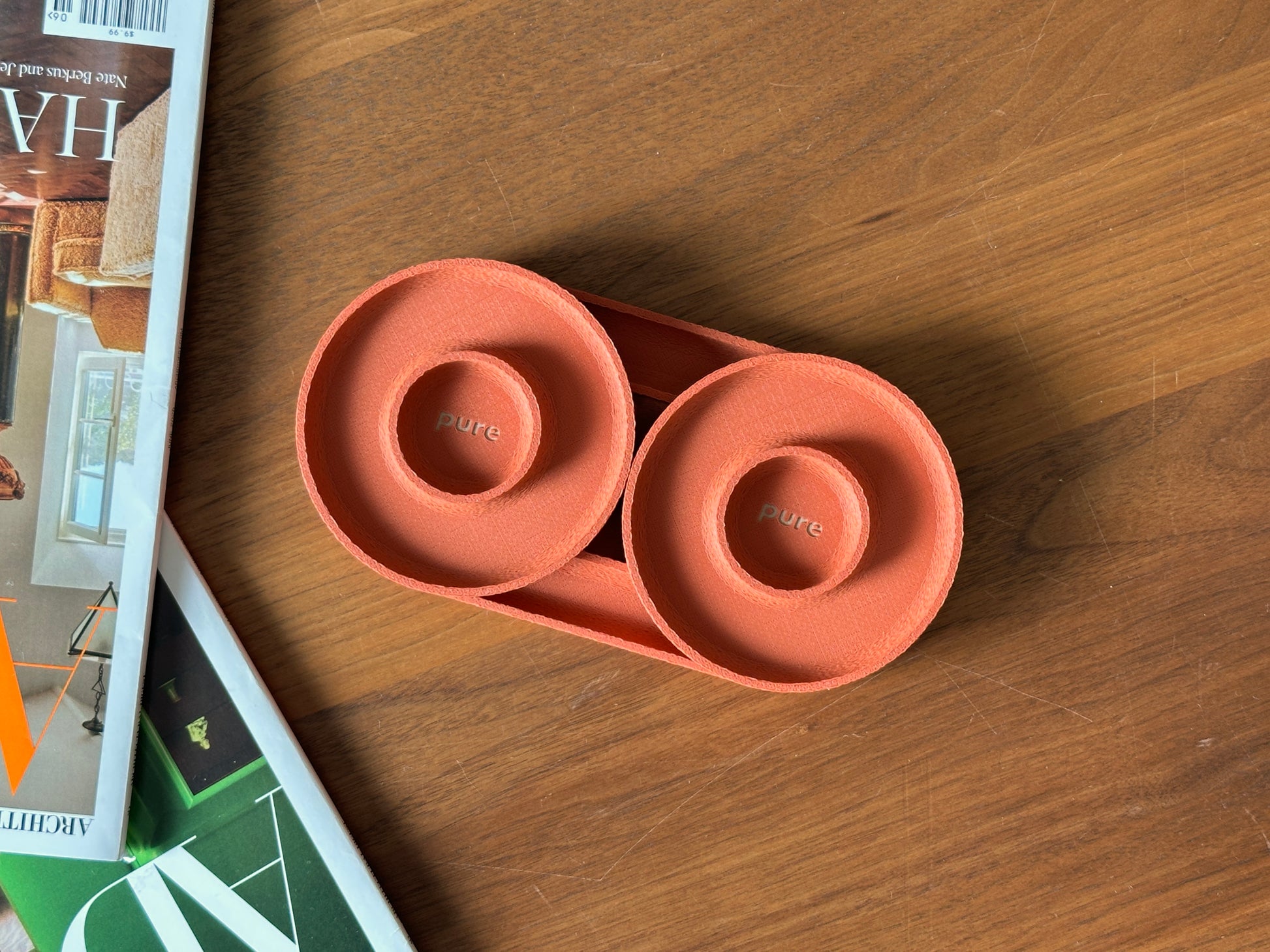 Terracotta pair of round ring dishes with raised center detail and matte textured finish.