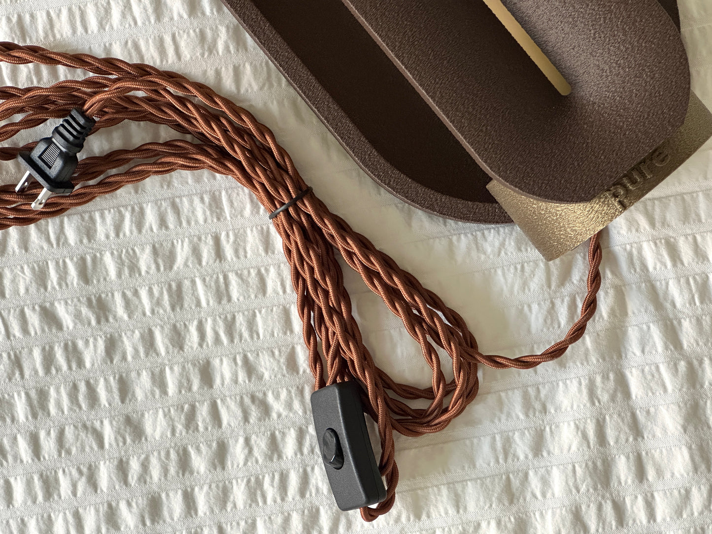 Close-up of the braided power cord and inline ON/OFF switch included with the Dune bedroom lamp.