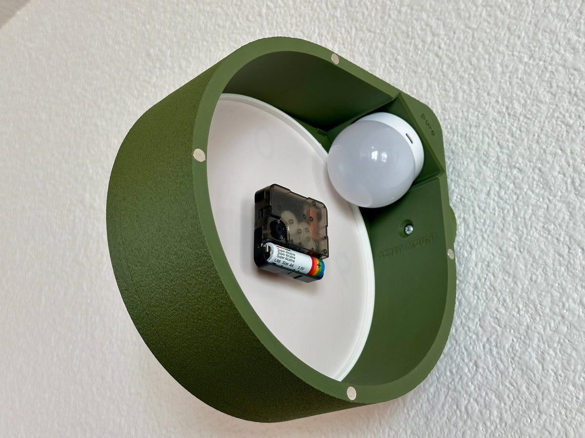 Rear view of the Cero double face clock showing the magnetic clock face, internal quartz movement and rechargeable backlight placement.